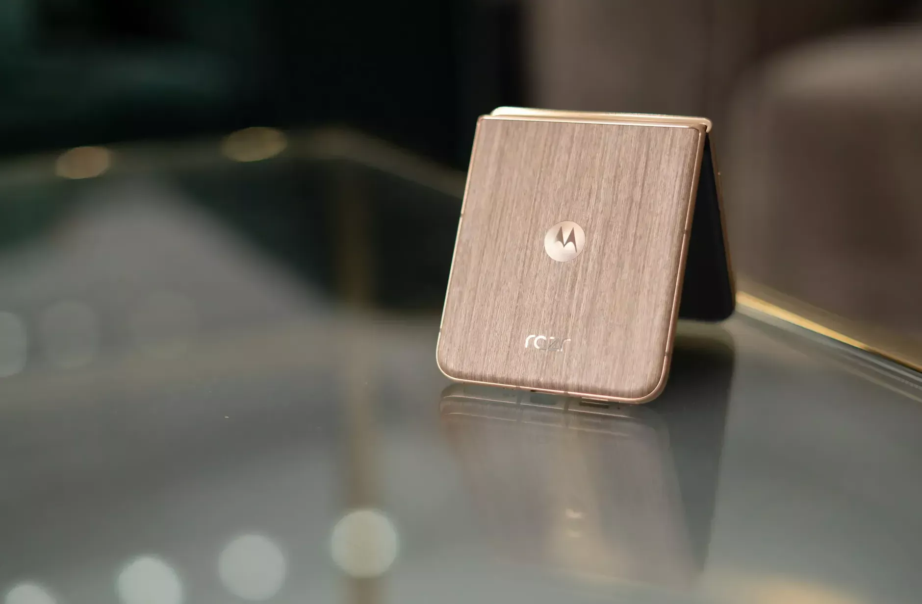 Motorola Razr Ultra 2025 with wood grain back shown on a table.