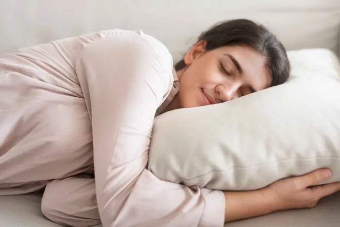 If you like hugging a pillow while sleeping, you might be a very caring person. According to a study from Communication Monographs, this caring nature often stems from parental behavior.