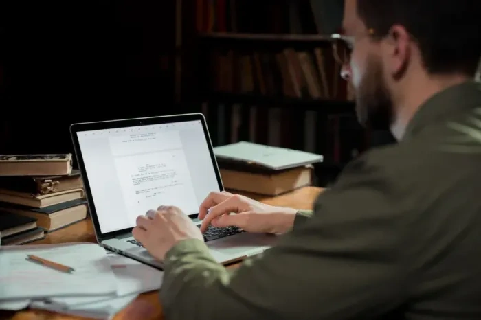 Writer checking article draft and quality checklist before publishing.