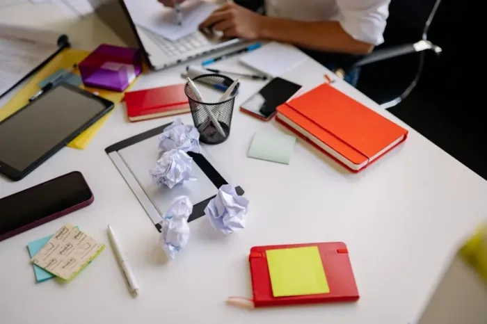 A person drafting a miniature work experiment at a desk