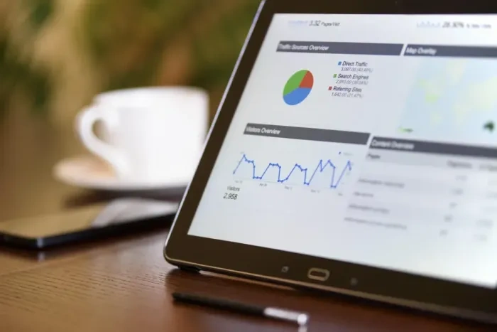A business owner reviews campaign results with graphs on a laptop