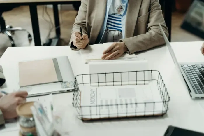 A person weighing career options at a desk before deciding on focus
