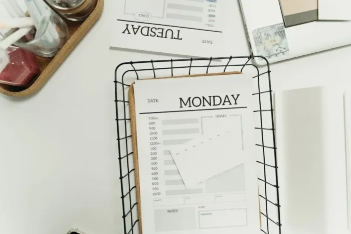 Professional arranging weekly work priorities in a planner